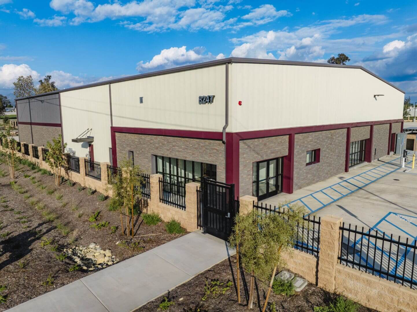 Industrial building with fenced perimeter and sidewalk.